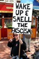 Activist with a wake up to fascism sign